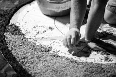 Cropped image of person doing artwork on footpath