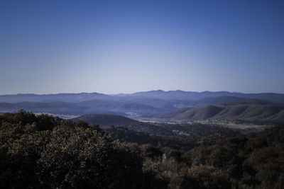 Scenic view of mountains against clear blue sky