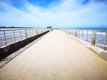 Scenic view of pier on sea against sky