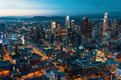 High angle view of illuminated buildings against sky at dusk