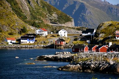 Houses by sea against mountains