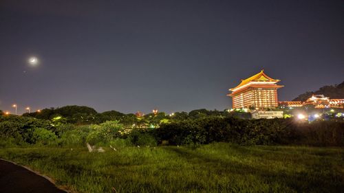 View of illuminated buildings against sky at night