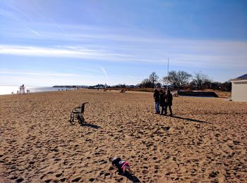 Low section of man on beach against sky