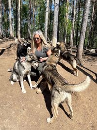 Women playing with huskies