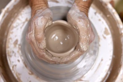 Cropped hand of man working at workshop