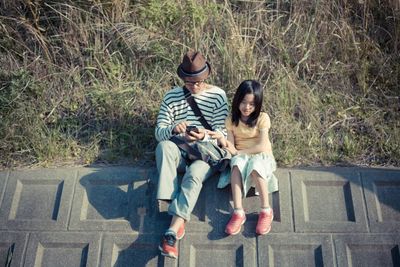 High angle view of girl sitting with father