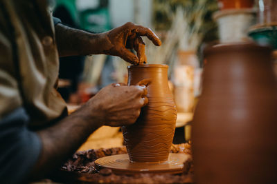 Close up mand working with clay