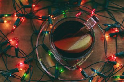 High angle view of drink amidst illuminated lights in darkroom