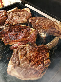 High angle view of meat on barbecue grill