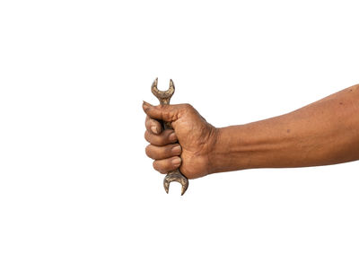 Close-up of man holding hands against white background