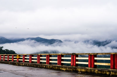 View of bridge against foggy mountains
