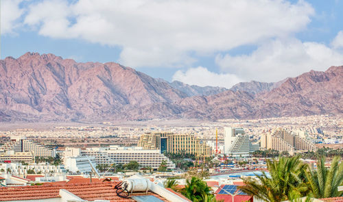 High angle view of townscape and mountains against sky