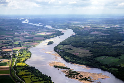 Aerial view of river amidst landscape against sky