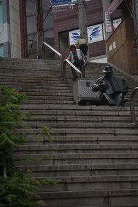 Woman on steps in city