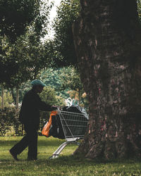 Man by tree in park