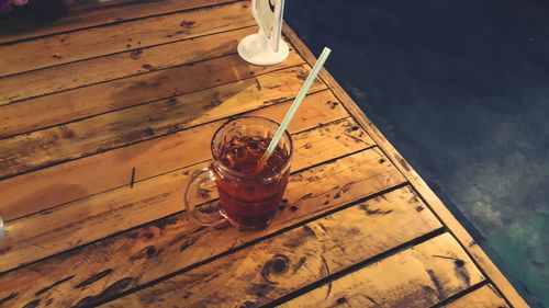 High angle view of drink in glass on pier