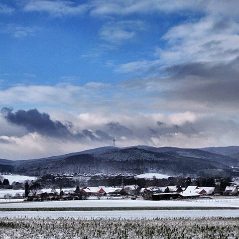 snow, winter, cold temperature, season, transportation, weather, sky, covering, landscape, mode of transport, cloud - sky, field, frozen, nature, car, white color, land vehicle, mountain, cloud, road