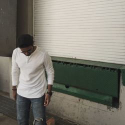 Young man standing on footpath