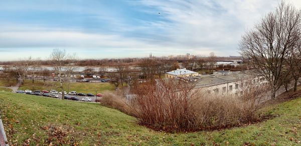 Panoramic shot of trees and buildings against sky