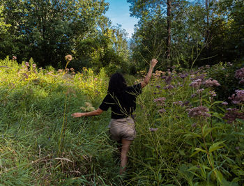 Rear view of woman standing on field