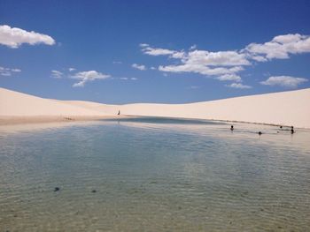 Scenic view of beach against blue sky