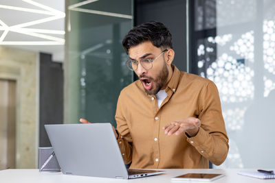 Young man using laptop on table