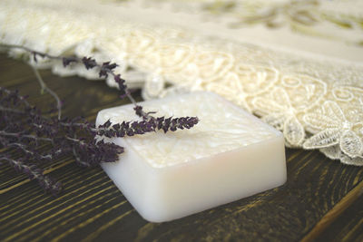 Homemade soap with herbs on wooden background