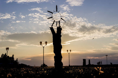 Silhouette street light against sky during sunset