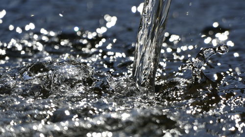 Close-up of water splashing against sky at night