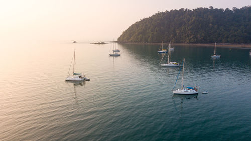 High angle view of boats sailing in sea against clear sky