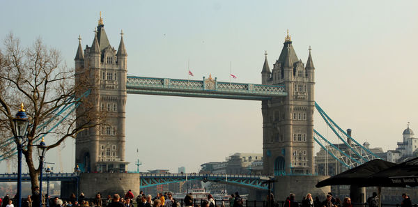 People on bridge against sky