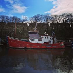 Boats moored in river