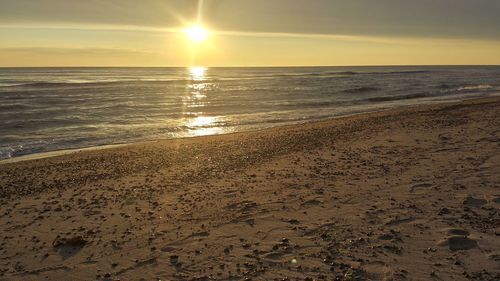 Scenic view of beach against sky during sunset