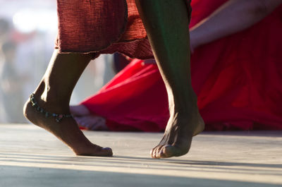 Low section of woman dancing outdoors