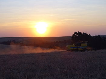 Scenic view of field against sky during sunset