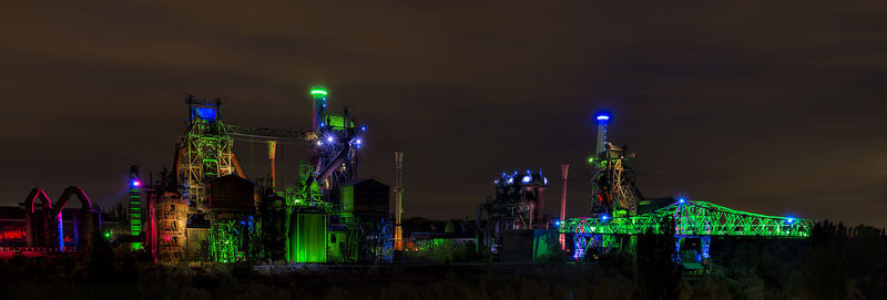 Illuminated modern buildings in city at night