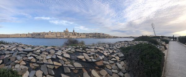 Panoramic view of river and buildings against sky