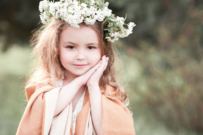 Portrait of girl wearing wreath at park