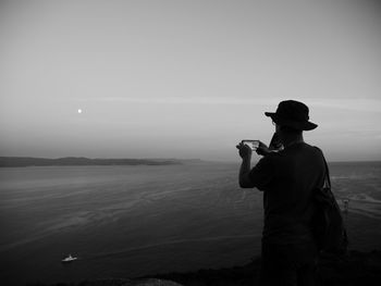 Man looking at sea against sky