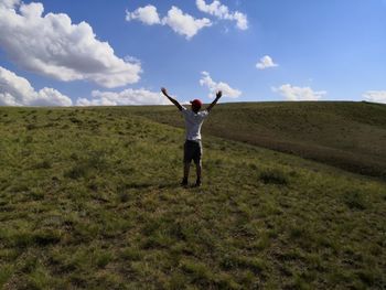 Rear view of person standing on field