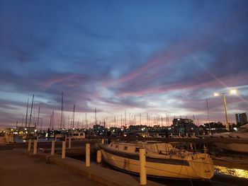Panoramic view of illuminated city against sky at sunset