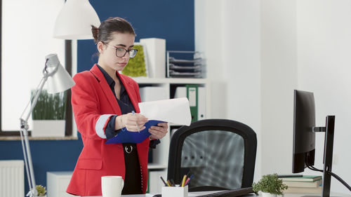 Young businesswoman standing in office