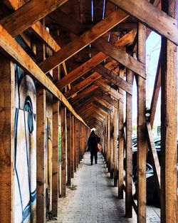 Rear view of woman walking in corridor