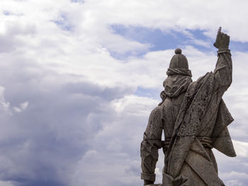 Low angle view of statue against sky