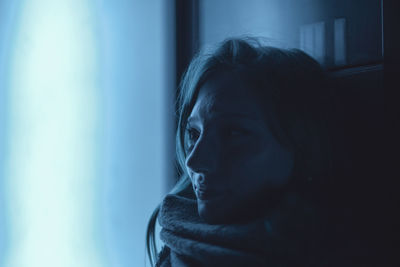 Close-up of woman looking away at home