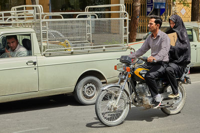 People riding bicycles on road in city