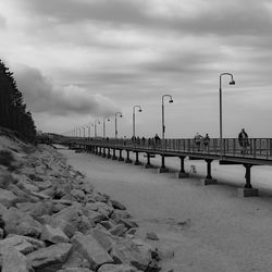 Pier over river against sky