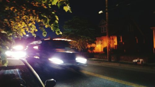 Illuminated city street at night