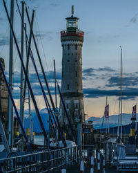 Sailboats in harbor against buildings in city