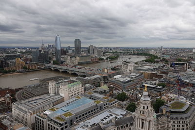 High angle view of city buildings against cloudy sky in city of london 